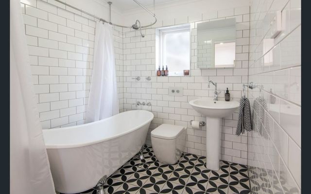 Freestanding bath in a renovated bathroom by Curtain Constructions