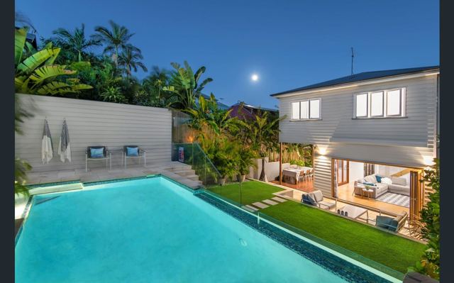Renovated home extension with twilight outdoor living and pool by Curtain Constructions